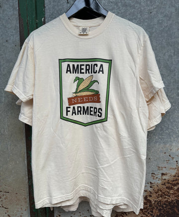 TNCC AMERICA NEEDS FARMERS TEE | IVORY